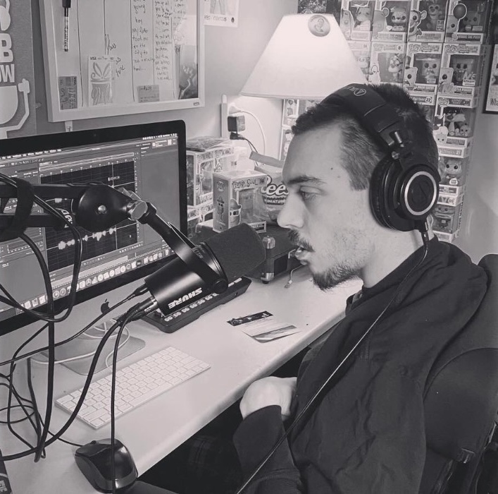 Bob Runkel recording at his home studio desk, wearing headphones